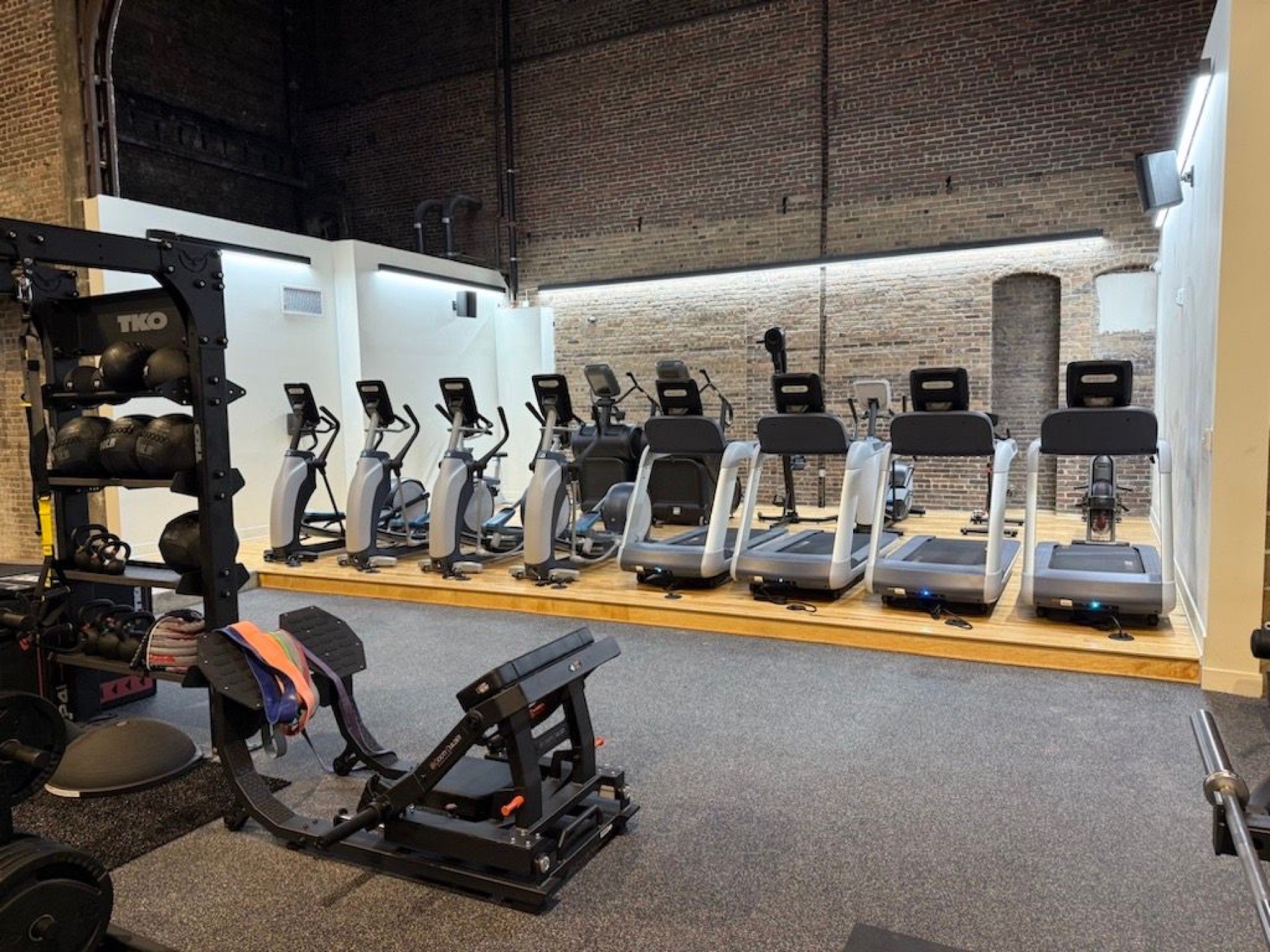 Cardio equipment and an open aisle at House of Iron Downtown