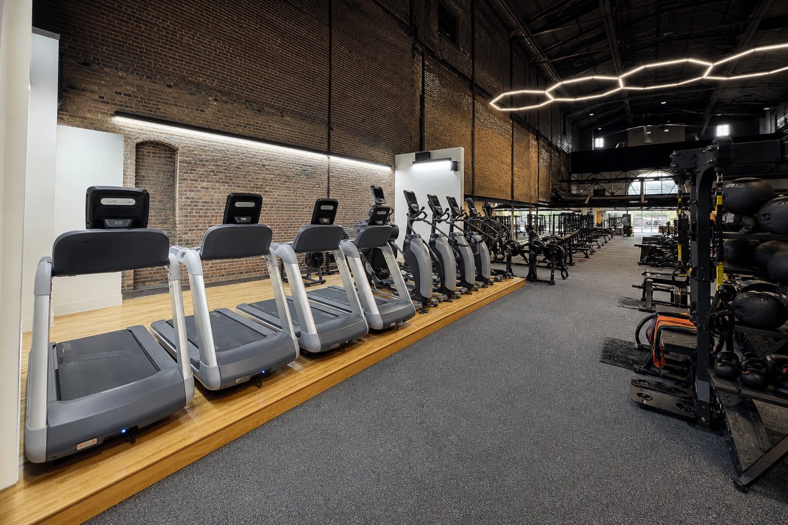Cardio equipment beside the historic brick Downtown training floor