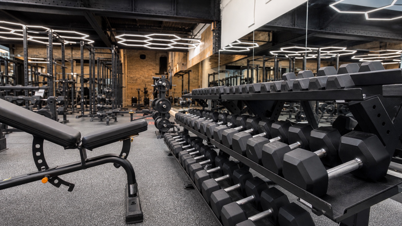 Dumbbells and an adjustable bench inside the Downtown training room