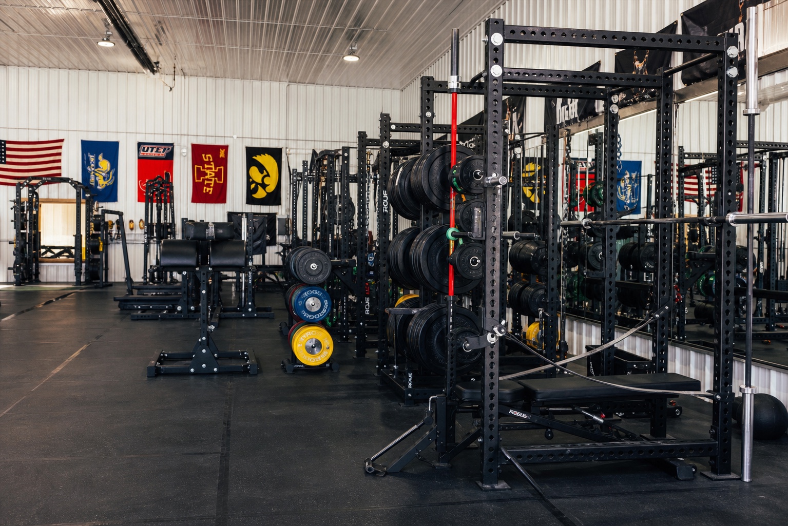 Power racks and organized plate storage at House of Iron Westside