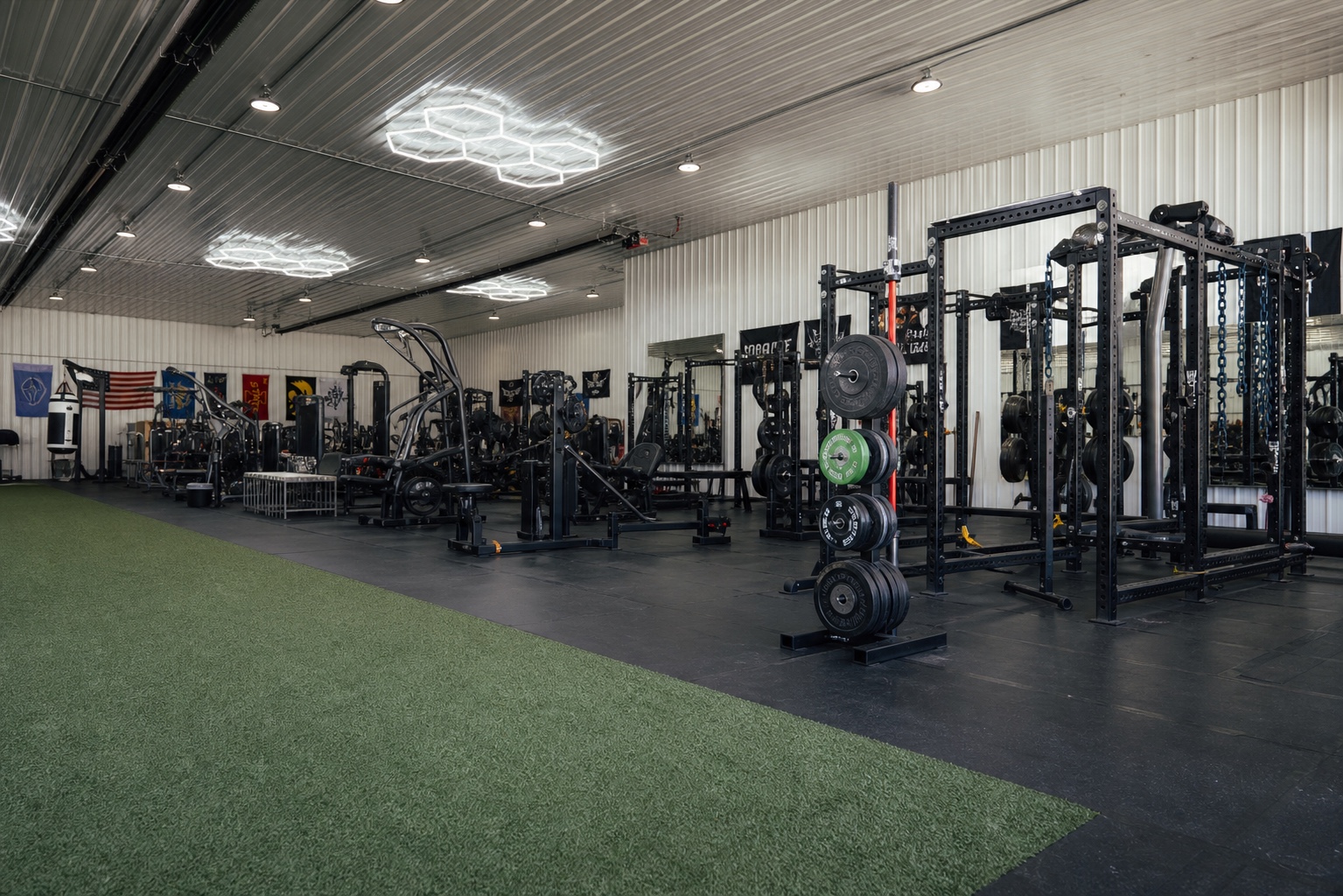 Green turf leading toward the rack floor at House of Iron Westside
