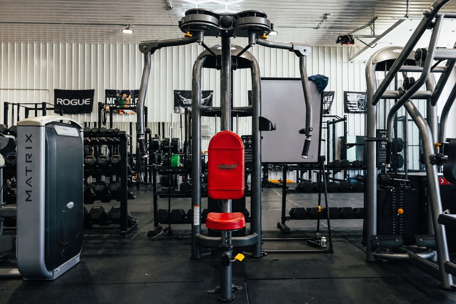 Westside strength floor beneath geometric ceiling lights