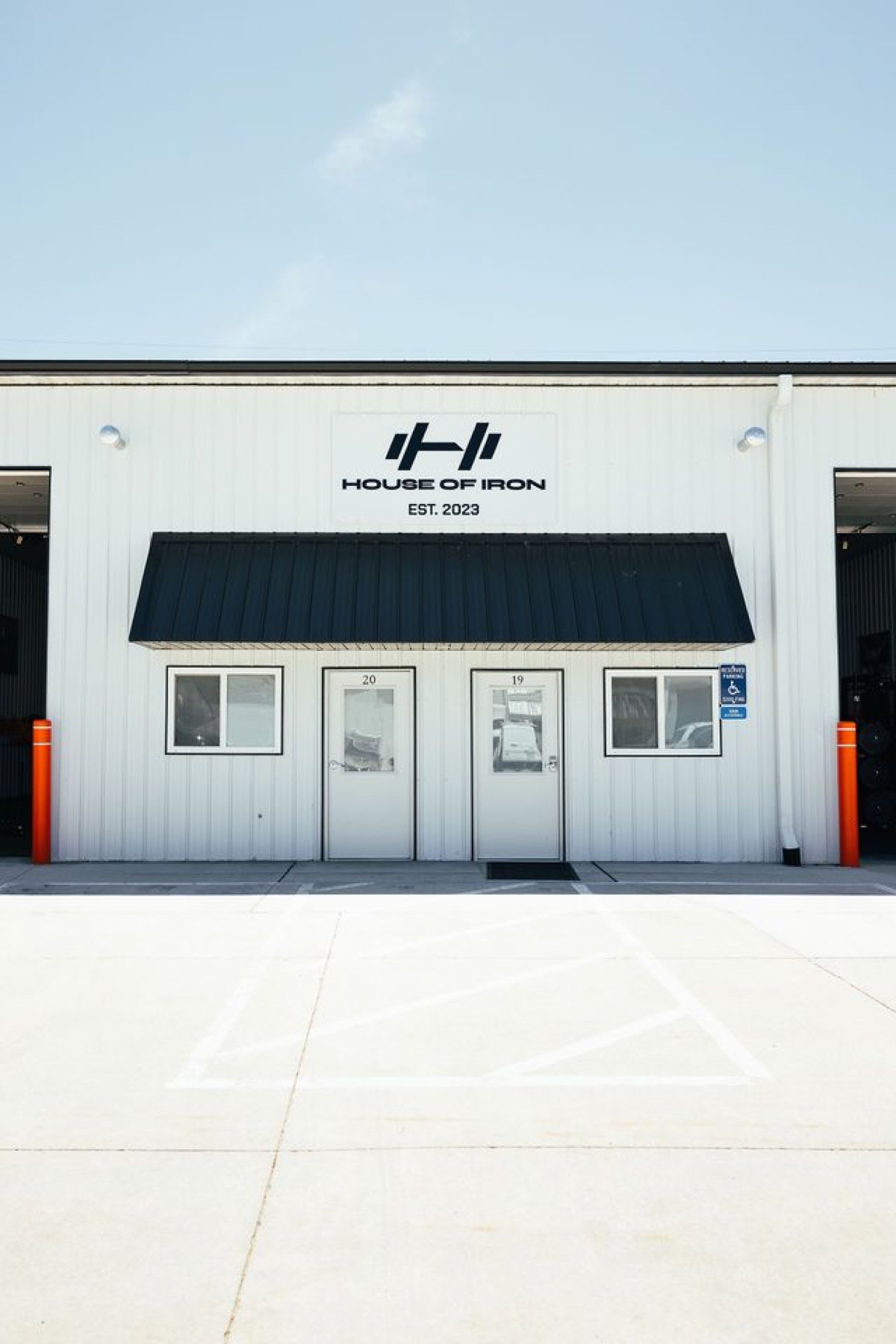White metal Westside facade, entry doors, and open training bays