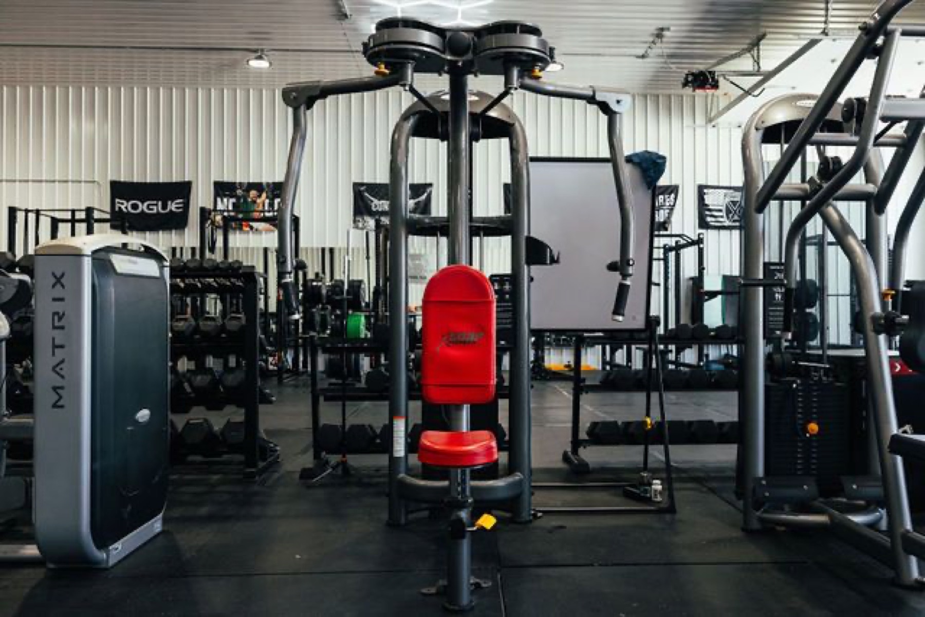 Rows of black strength machines on the Westside rubber floor